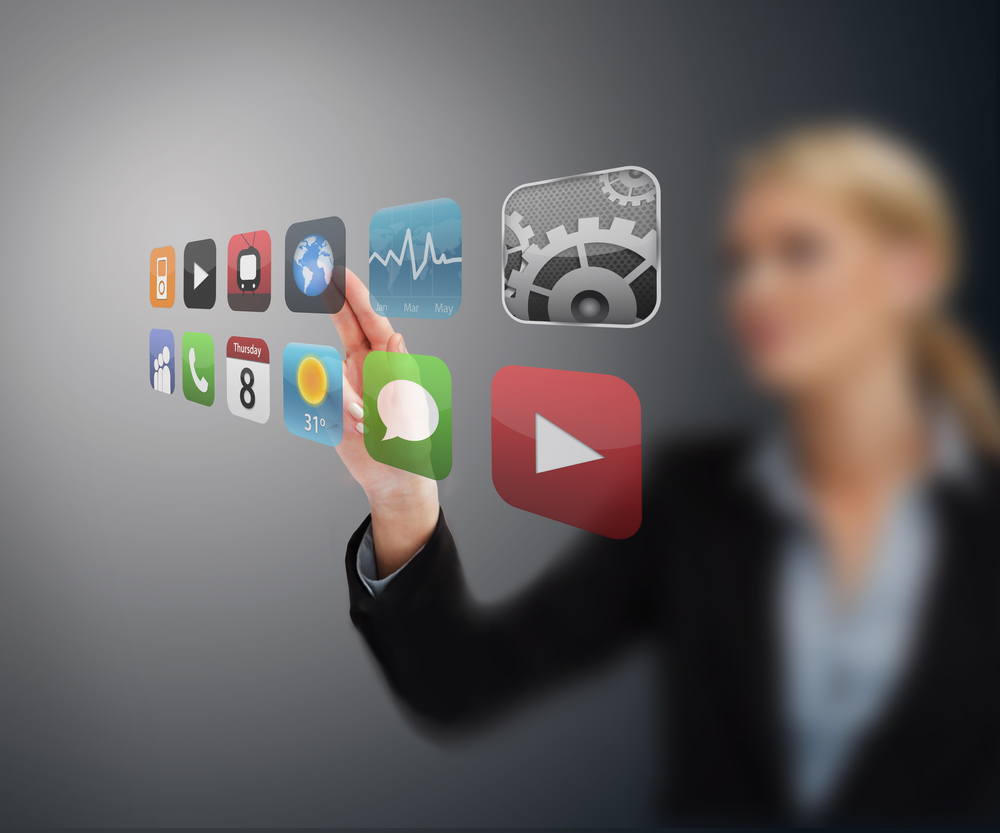 Businesswoman touching application from hologram touchscreen menu